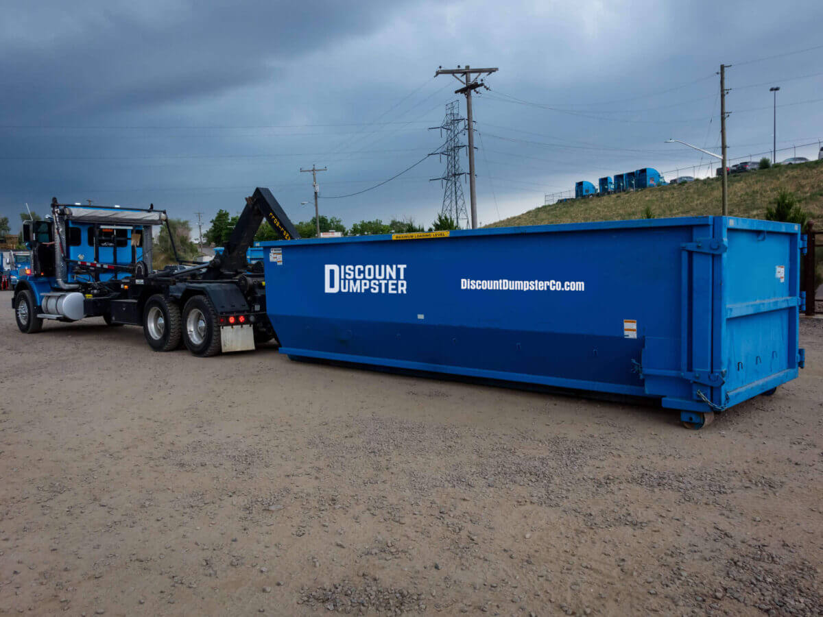 filled dumpster being hauled away in Omaha city