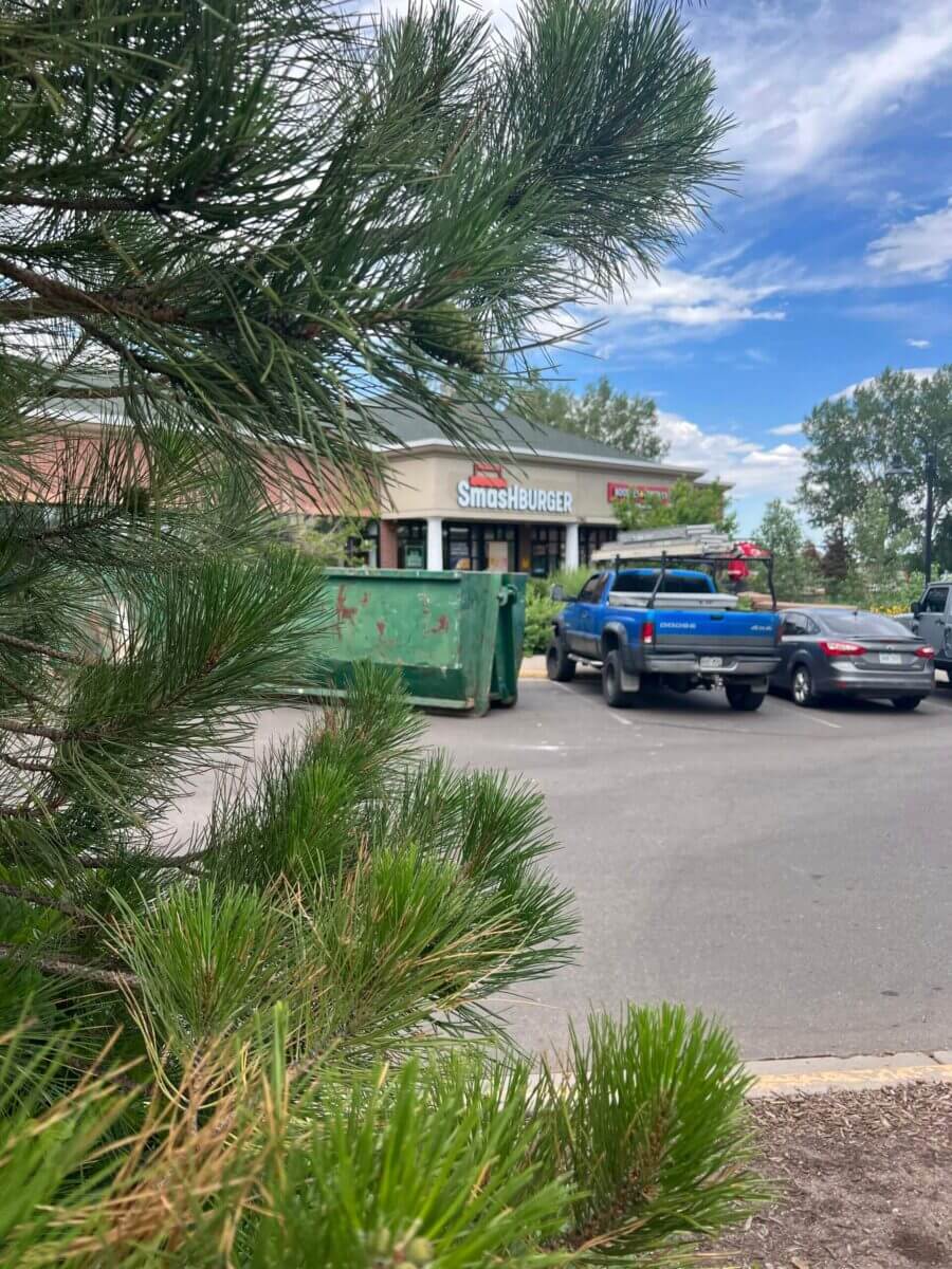 Photo of a green dumpster rental in Denver, CO