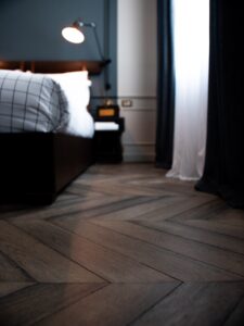 An image of a vinyl floor and bed.