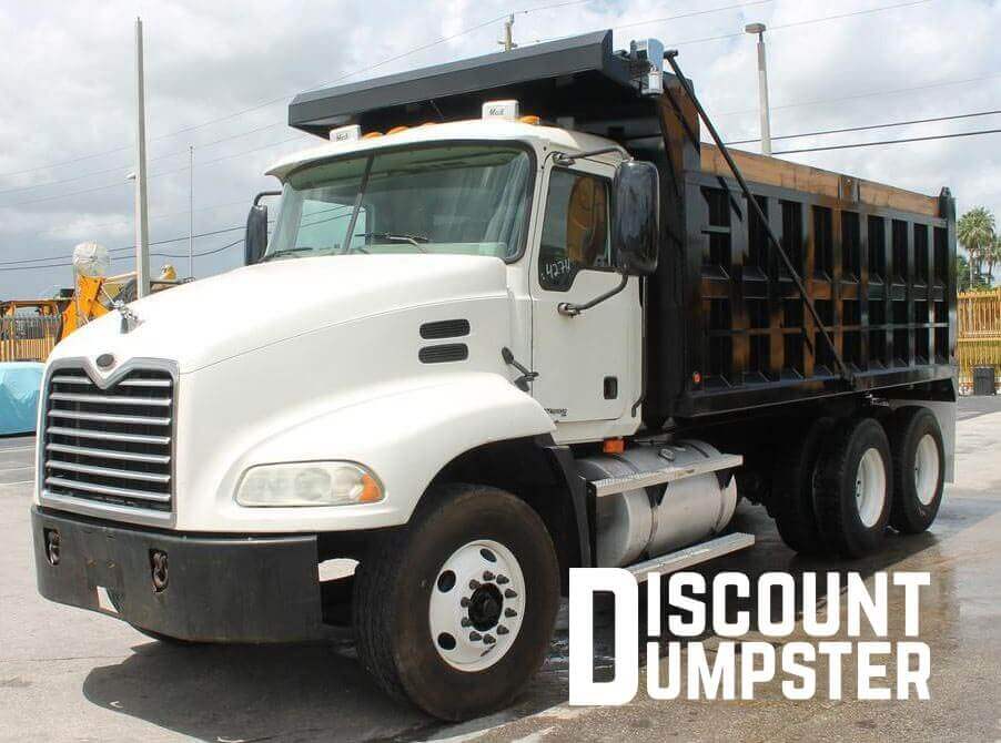 discount dumpster roll-off dumpster being hauled away 