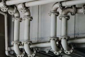 White plumbing pipes inside a home